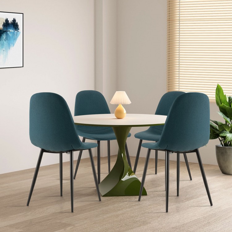 Four blue dining chairs with black metal legs around a round table, featuring foam upholstery for comfortable seating.